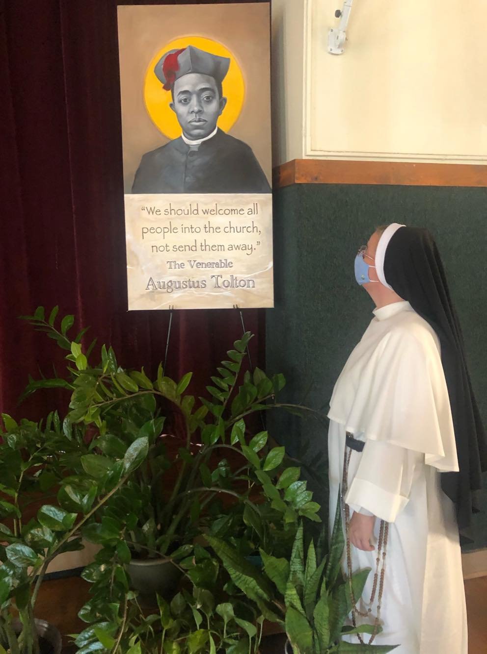 Fourth-grade teacher Dominican Sister Mary Olivia Shirley admires the image in the auditorium of St. Anthony of Padua School in Washington, D.C., on the first day of this academic year.